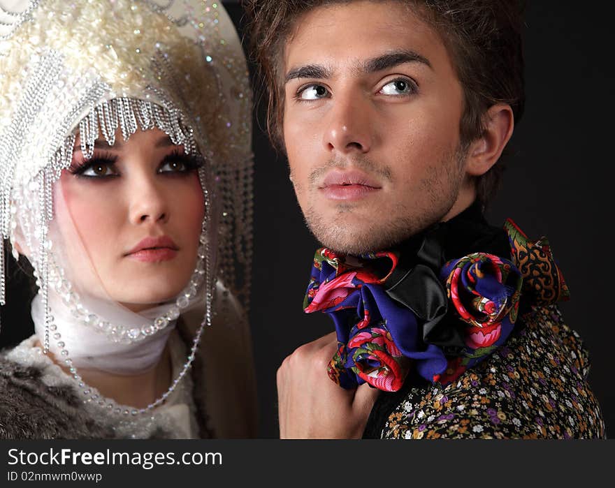 Pair models in exclusive design clothes on manners old-slavic. Photo.