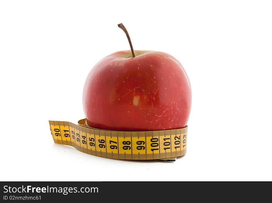 Yellow tape measure around a red apple