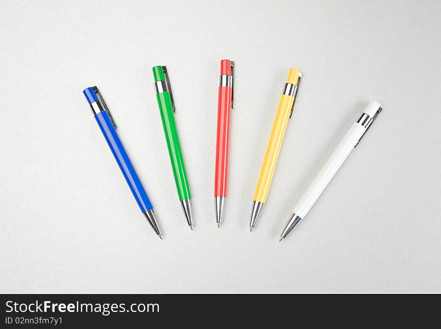Set of colored pens on grey table. Set of colored pens on grey table