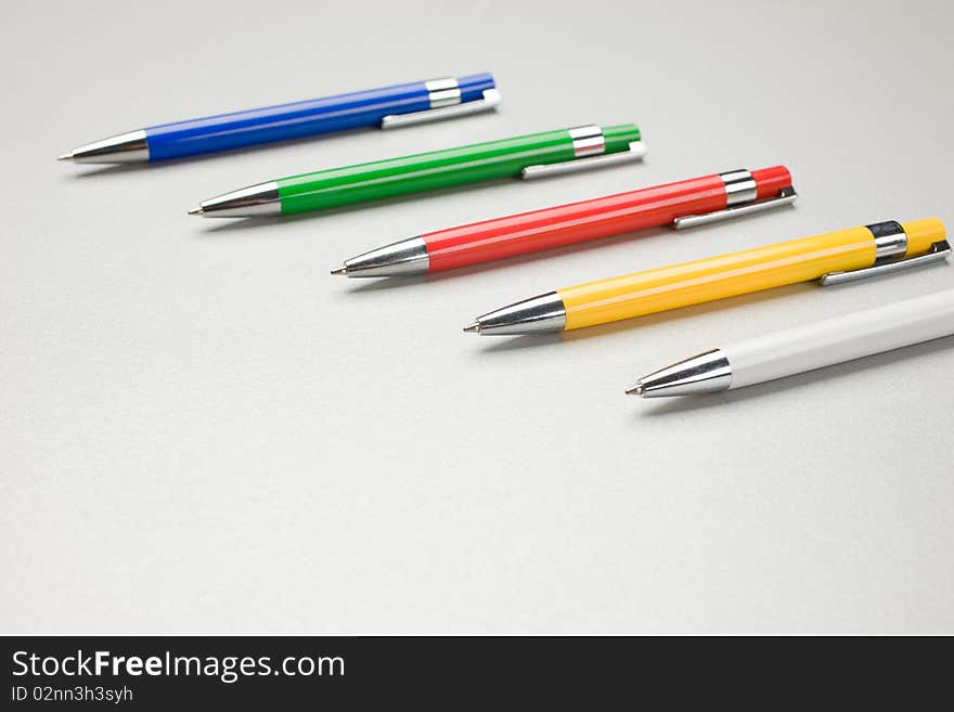 Set of colored pens on grey table. Set of colored pens on grey table