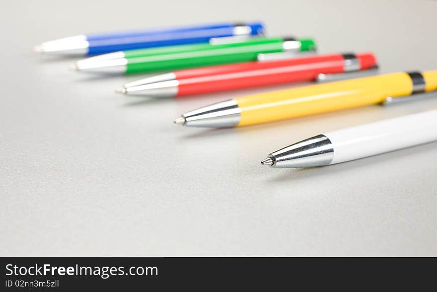 Set of colored pens on grey table. Set of colored pens on grey table