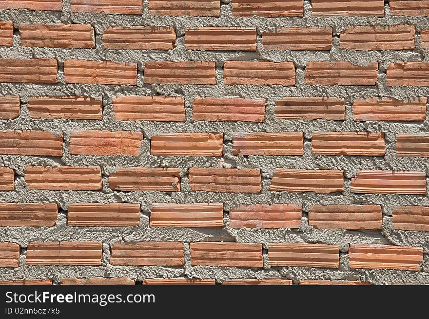 Brown color brick wall in the similar pattern