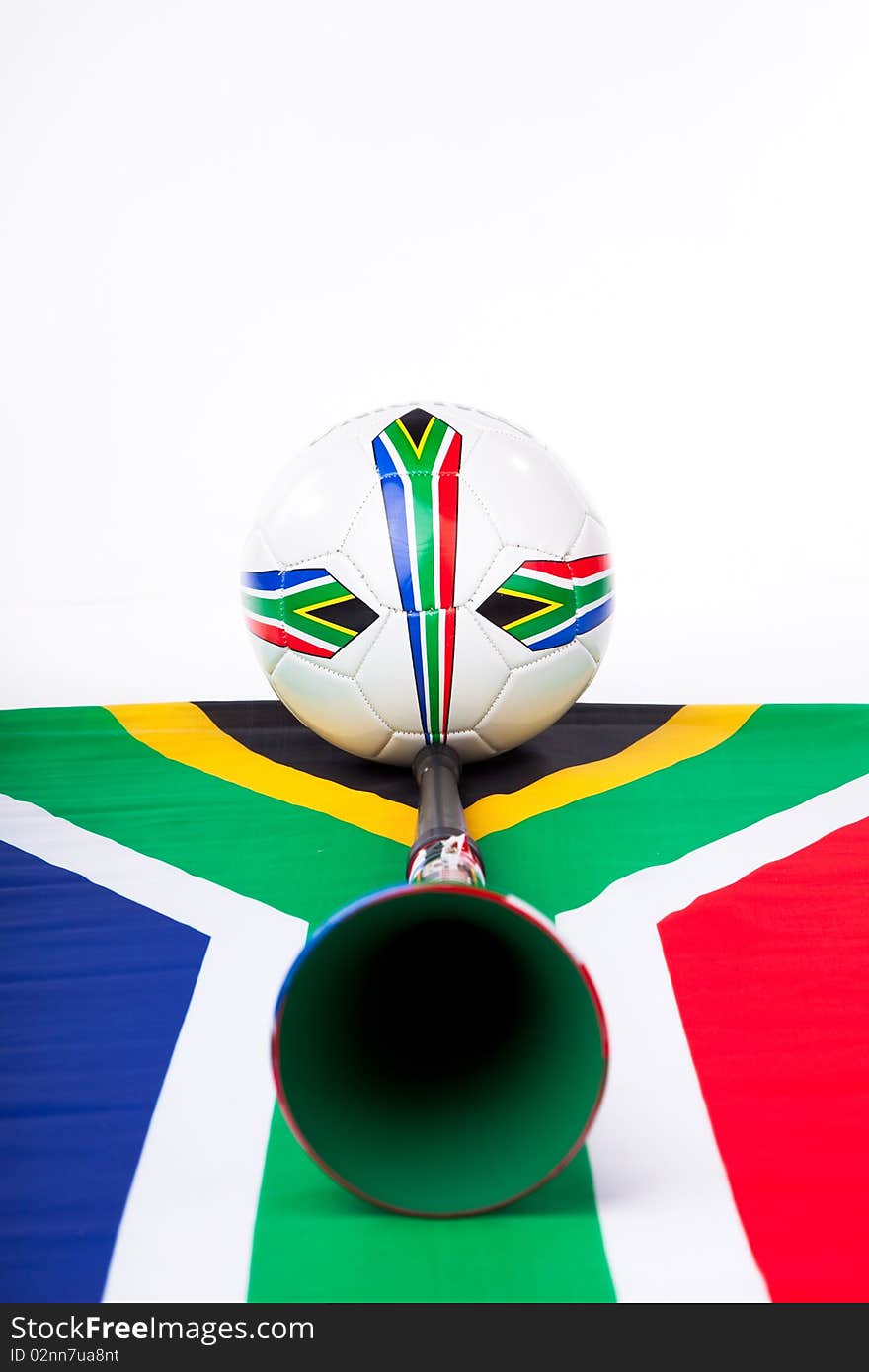 Image of a soccer ball on a South African flag with a Vuvuzela and team flags. Image of a soccer ball on a South African flag with a Vuvuzela and team flags