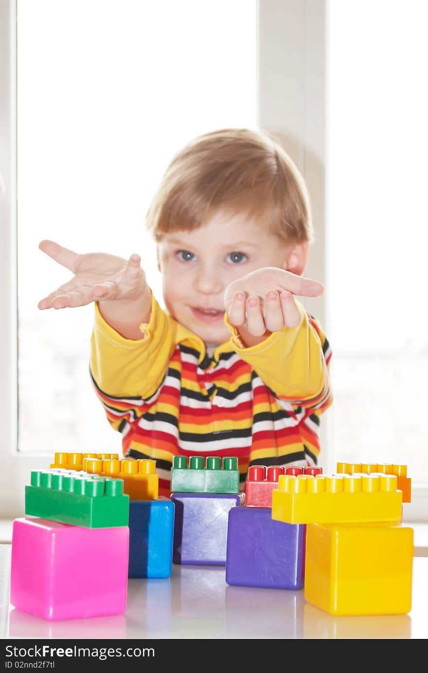 The beautiful little boy poses on a light background. The beautiful little boy poses on a light background