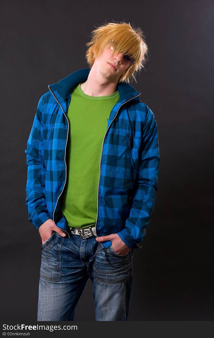 Young emo man posing in dark studio. Young emo man posing in dark studio