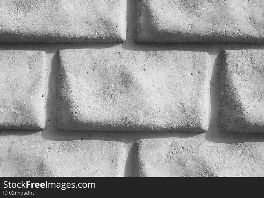 A light grey brick wall. A light grey brick wall