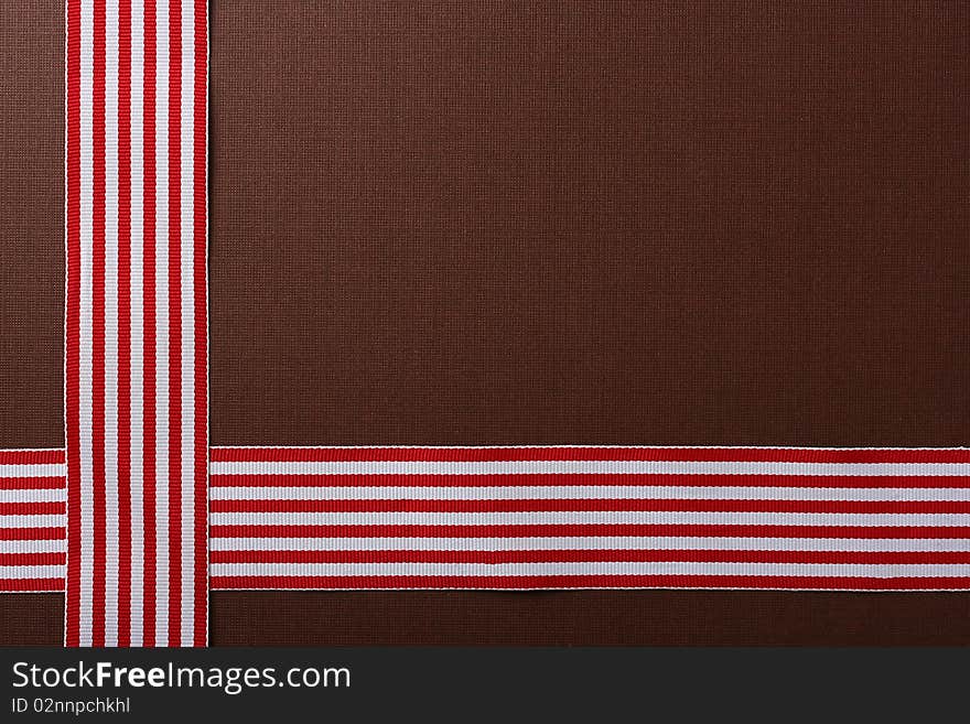 Brown background with two red-white tapes for design works.