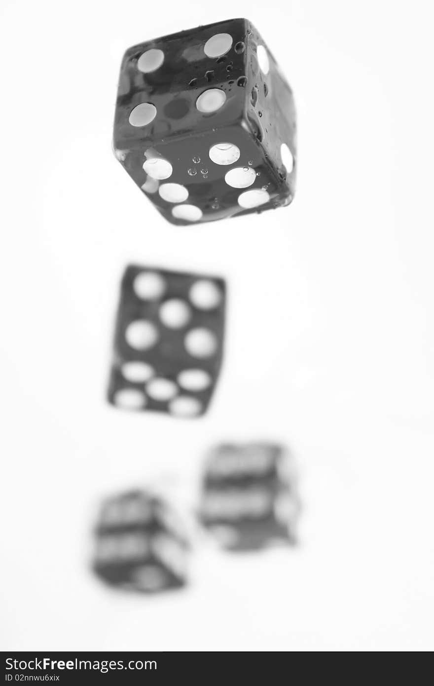 Four black and white playing bones