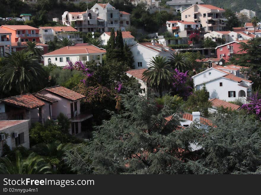 Bleached small houses with tile roofs in greens. Budva, Montenegro. Bleached small houses with tile roofs in greens. Budva, Montenegro.