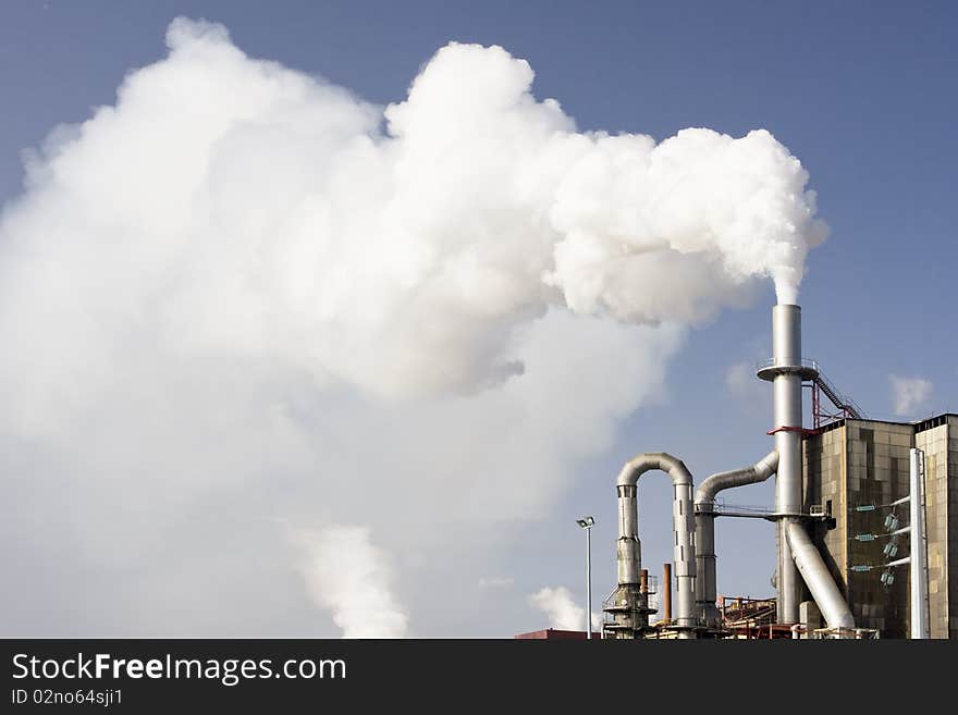 Scary image of white smoke coming out of industrial chimney (ecology problems)