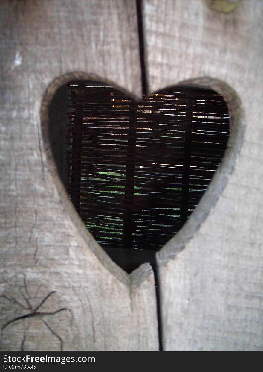 A heart cut out from an old wooden toilet door. A heart cut out from an old wooden toilet door