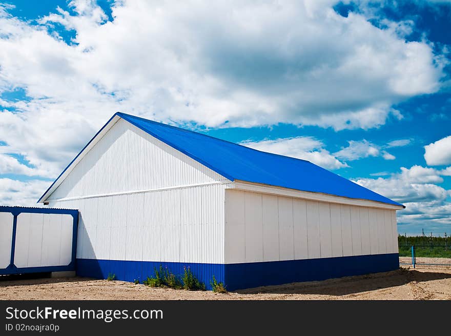 White building with a blue roof