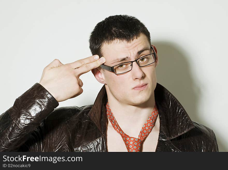 Tired man puts two fingers to his head as a gun