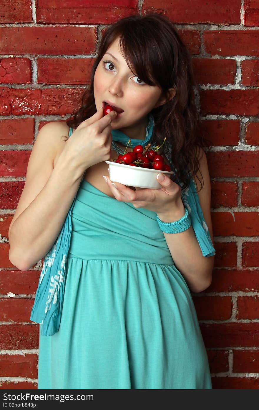 Beautiful woman eating cherry