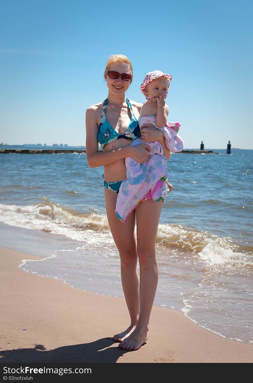 Mother with the baby  on the beach