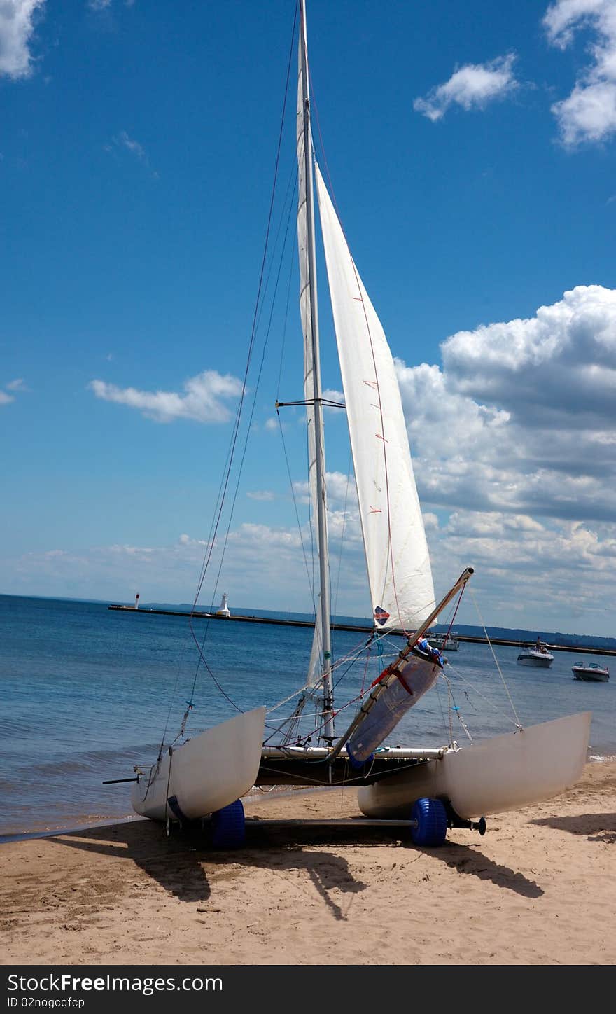 Boat in a lake ready to sail with blue sky and white clouds