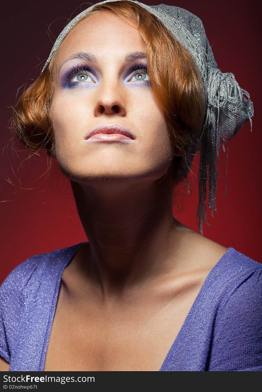 Portrait of attractive retro-style girl in bonnet over red