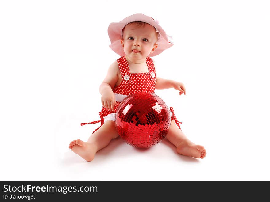 Little baby girl in red dress and hat with red ball