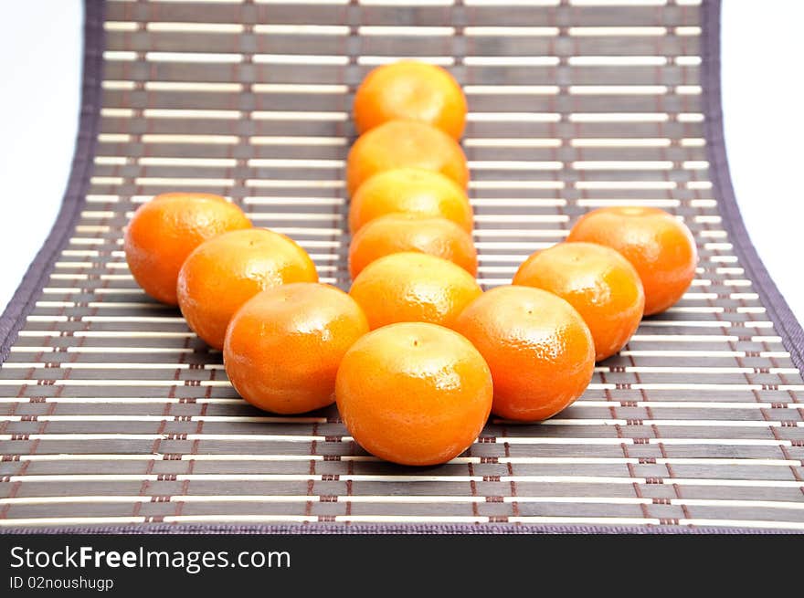 Mandarin baby orange on bamboo table cloth