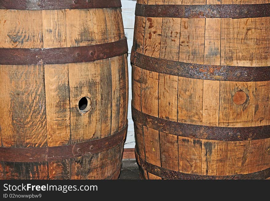 A close-up image of two barrels. The rusty rings along with the grainy wood on the barrels give it a vintage feel. A close-up image of two barrels. The rusty rings along with the grainy wood on the barrels give it a vintage feel.