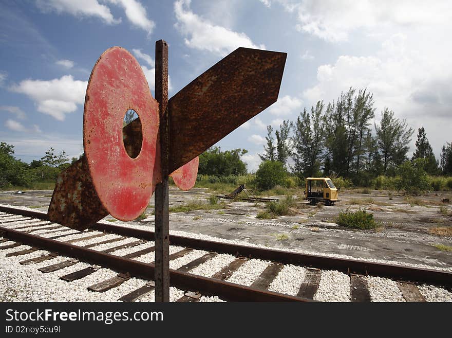 An abandoned railroad yard with a light rail car in the background. An abandoned railroad yard with a light rail car in the background.
