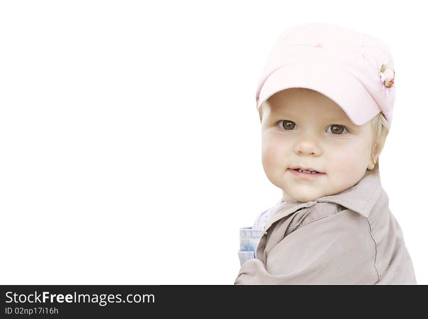 The joyful child in a pink cap looks back back. The joyful child in a pink cap looks back back