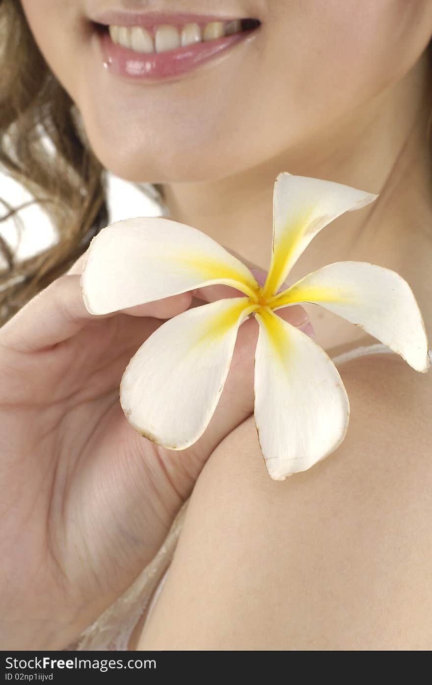 young woman holding white frangipani. young woman holding white frangipani