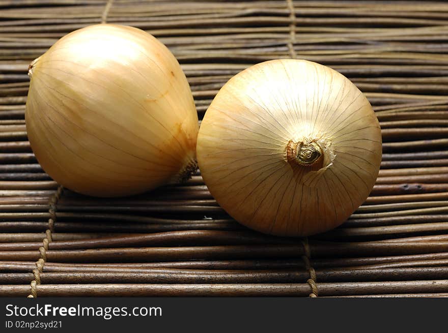 Pair of onions on bamboo mat