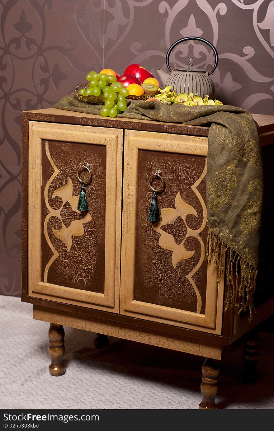 Wooden chest of drawers in east style with fruits