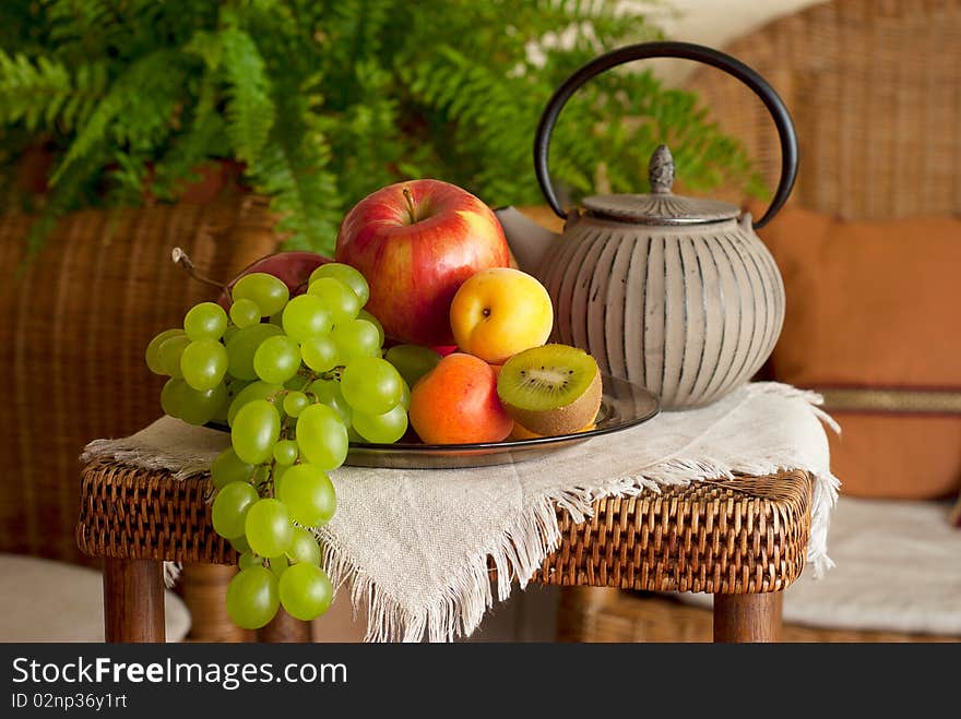 Beautiful still life image of fruits and teapot in