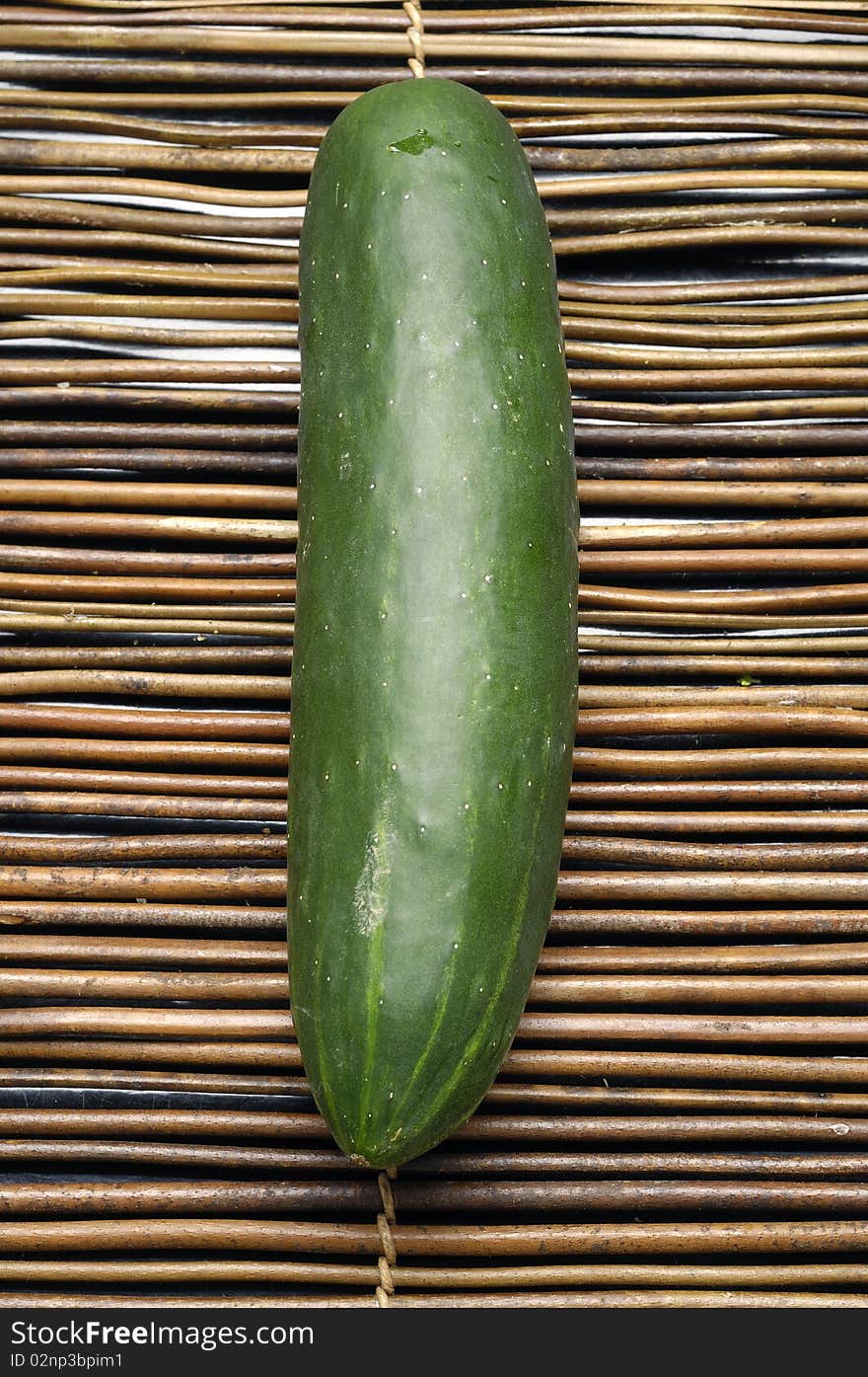 Fresh green cucumber vegetable on bamboo mat