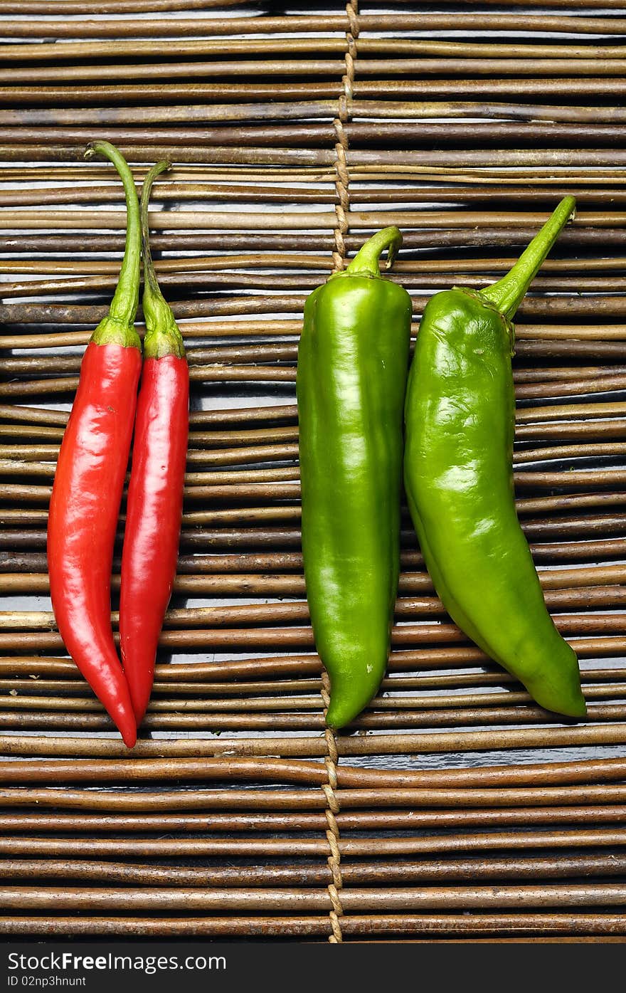 Red and green chili peppers on bamboo. Red and green chili peppers on bamboo