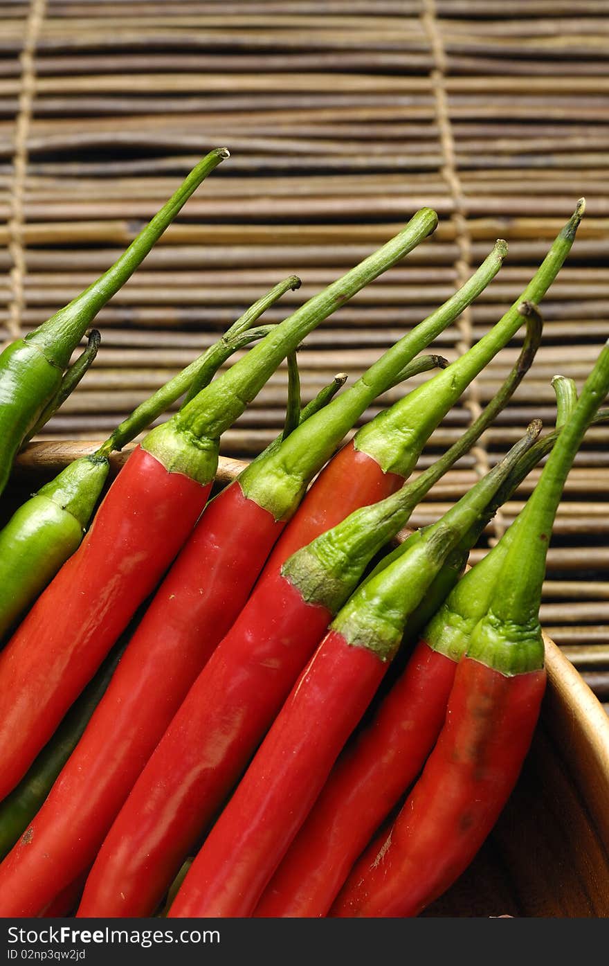 Red and green chili peppers on bamboo mat. Red and green chili peppers on bamboo mat