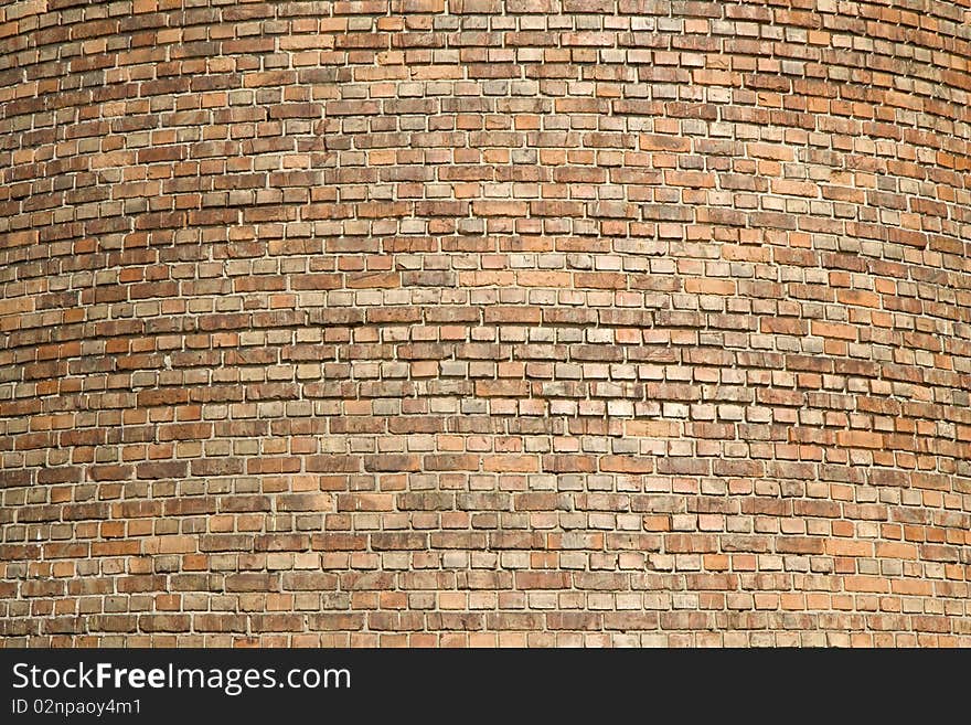 Old tower from small multi-coloured bricks