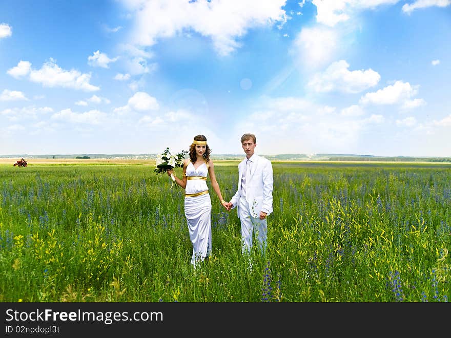 Just married couple on the green field