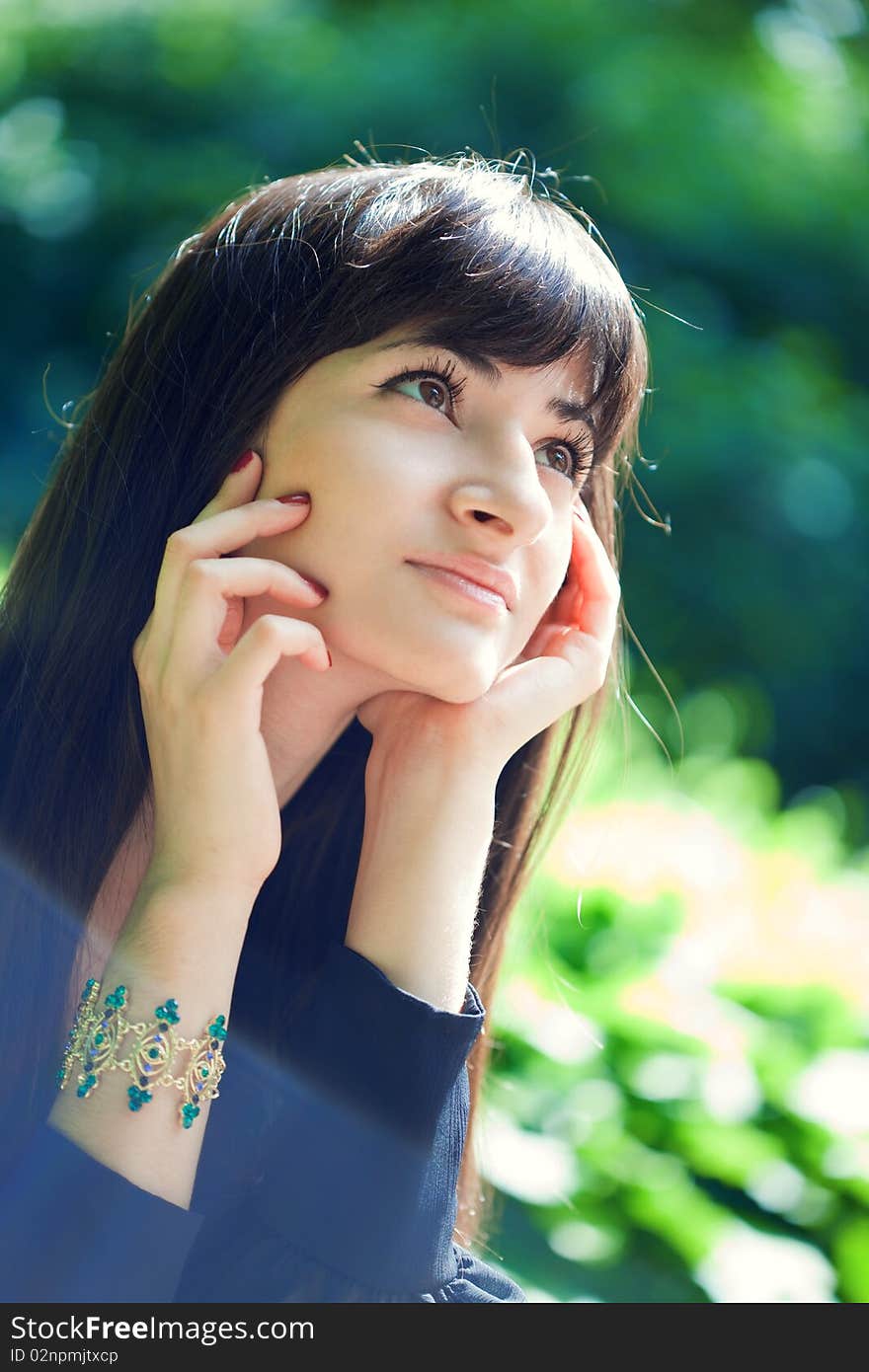 Young beautiful girl with long black hair, outdoors