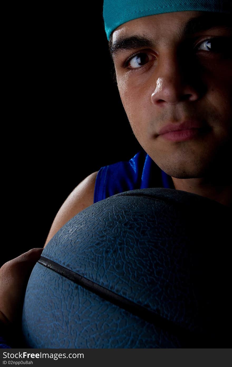 Young teenage basketball player in a studio setting with hip athletic clothing. Young teenage basketball player in a studio setting with hip athletic clothing.