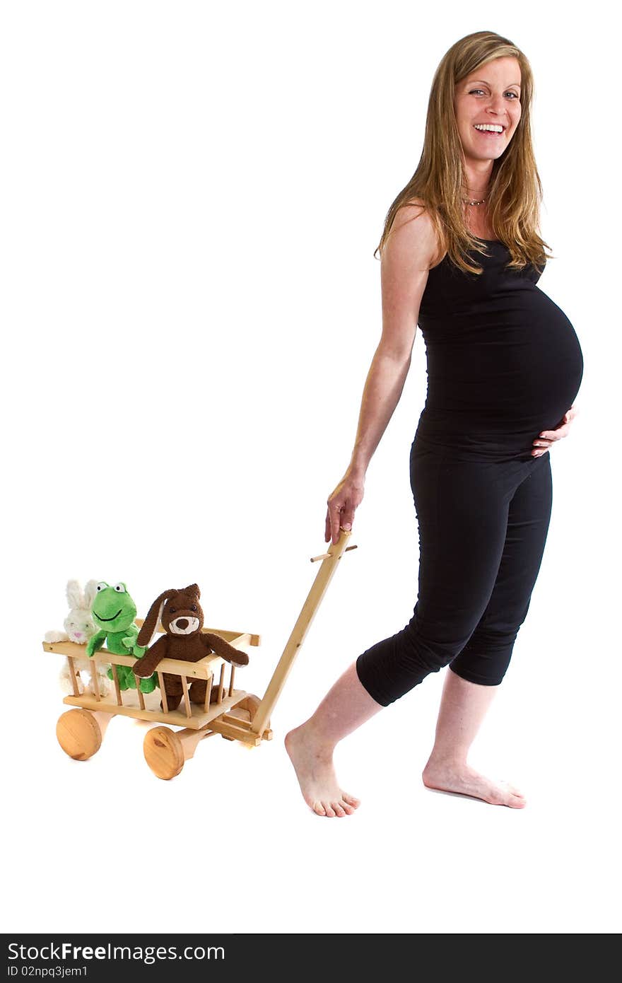 Young fresh pregnant woman is pulling  a trolley filled with toy animals isolated over white background. Young fresh pregnant woman is pulling  a trolley filled with toy animals isolated over white background.