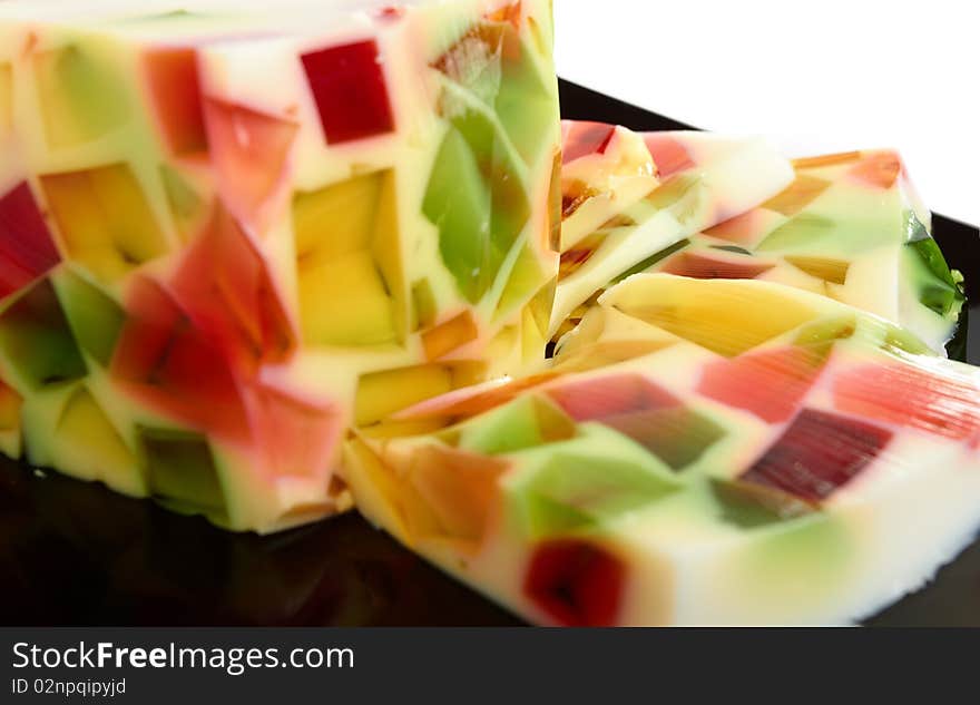 Fruit jelly on black plate close-up