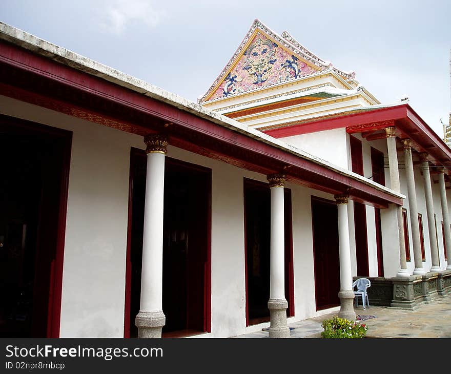 A beautiful Main temple hall.It located near side walk of temple area.Temple located  in Bangkok Thailand.It color white and red.
It an ancient buiding.