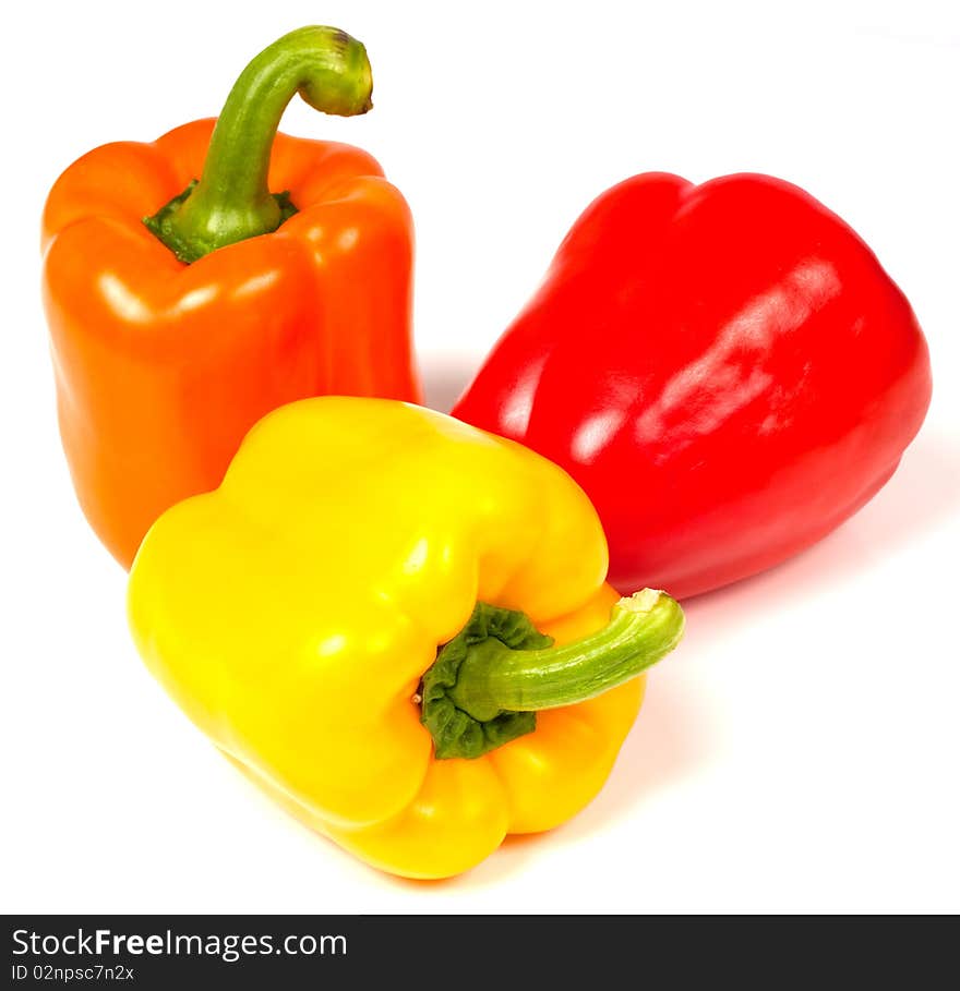 Red orange and yellow pepper on white background. Red orange and yellow pepper on white background