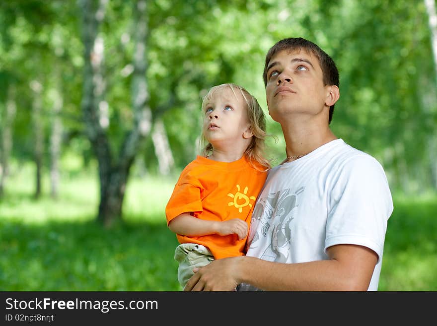 Father and son in his hands watching up outdoors