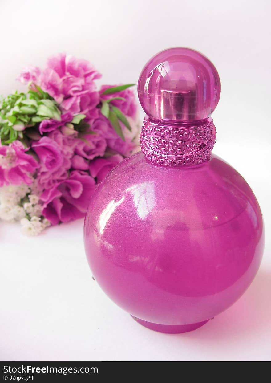 Bottle of perfume and flowers