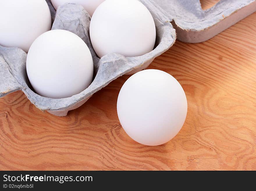 Eggs of white colour are combined in a special tray for transportation and sale.