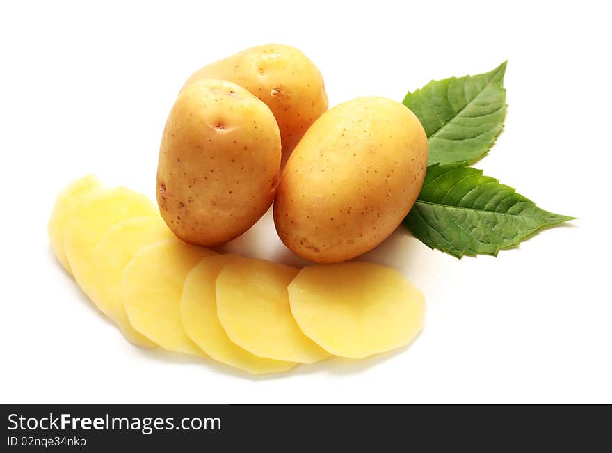 Isolated raw potatos with green leaves on white baclground. Isolated raw potatos with green leaves on white baclground