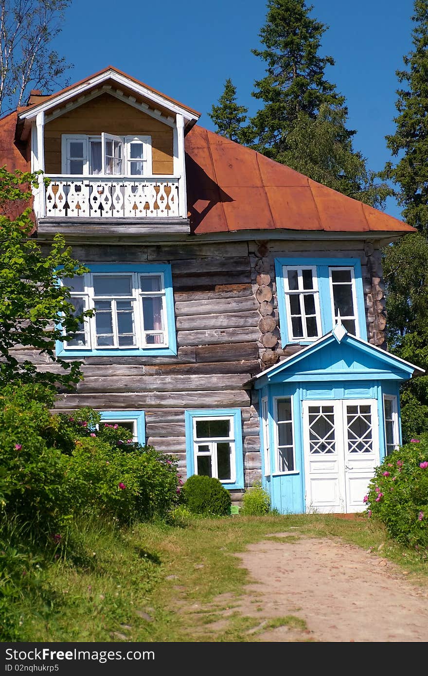 Exterior of traditional wooden house in countryside with trees in background, Karelia, Russian Federation. Exterior of traditional wooden house in countryside with trees in background, Karelia, Russian Federation.