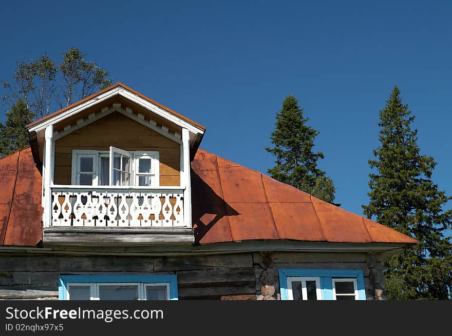 Exterior of traditional wooden house in countryside with trees in background, Karelia, Russian Federation. Exterior of traditional wooden house in countryside with trees in background, Karelia, Russian Federation.