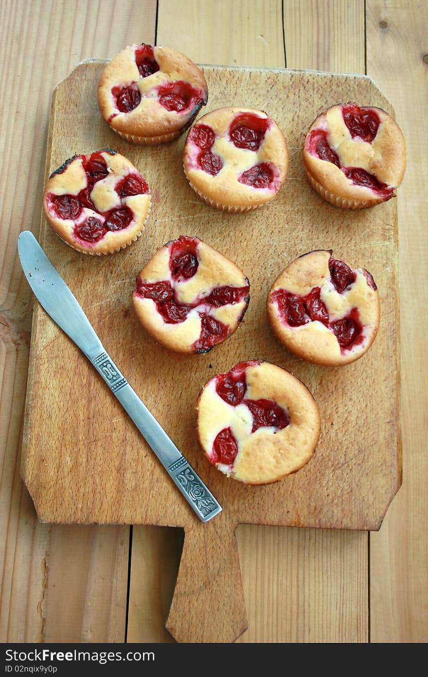 Delicious cherry muffin on a wooden table