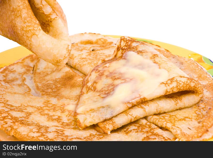 Pancakes with a butter on a white background