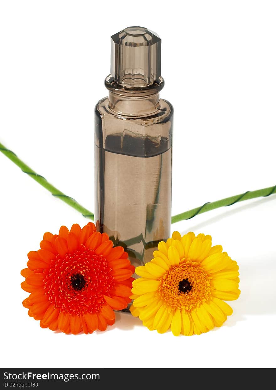 Perfume flask with flowers isolated on white background